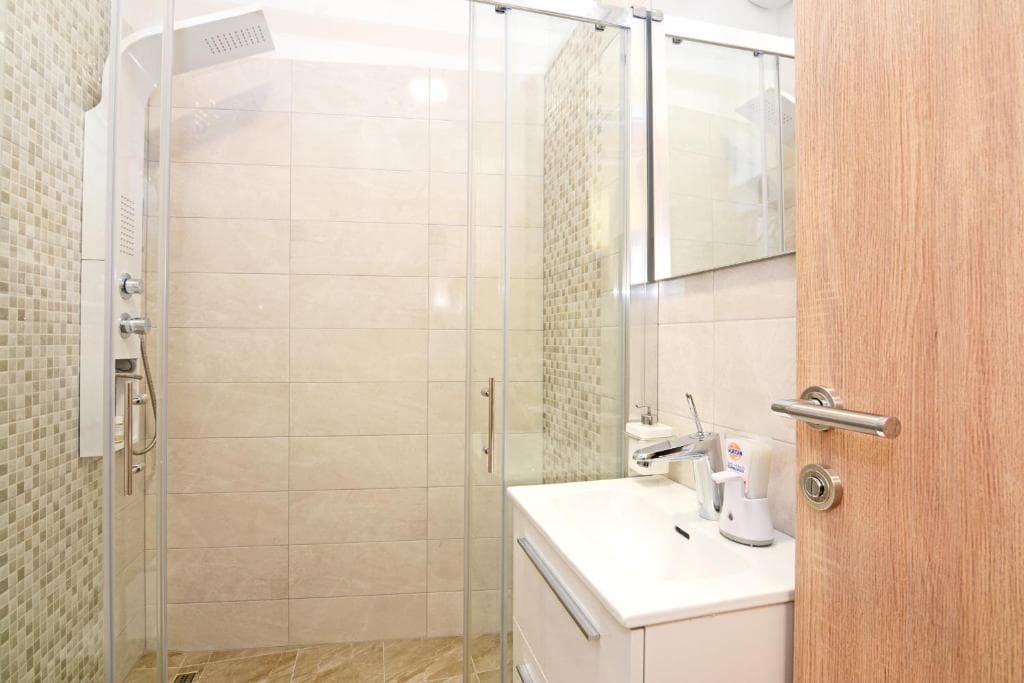 Bathroom with a glass shower enclosure and a washbasin